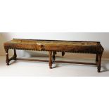 A large rectangular oak Footstool, of low proportions, with brass studs, a wooden standard Lamp,