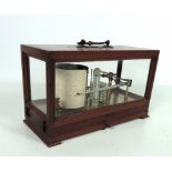 A good Edwardian brass mounted Barograph, with hinged top glazed on four sides, with clockwork drum,