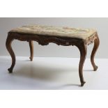 A Victorian walnut Window Stool, the drop in seat with floral tapestry decoration,