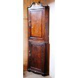 A George III stained oak two part Corner Cabinet,