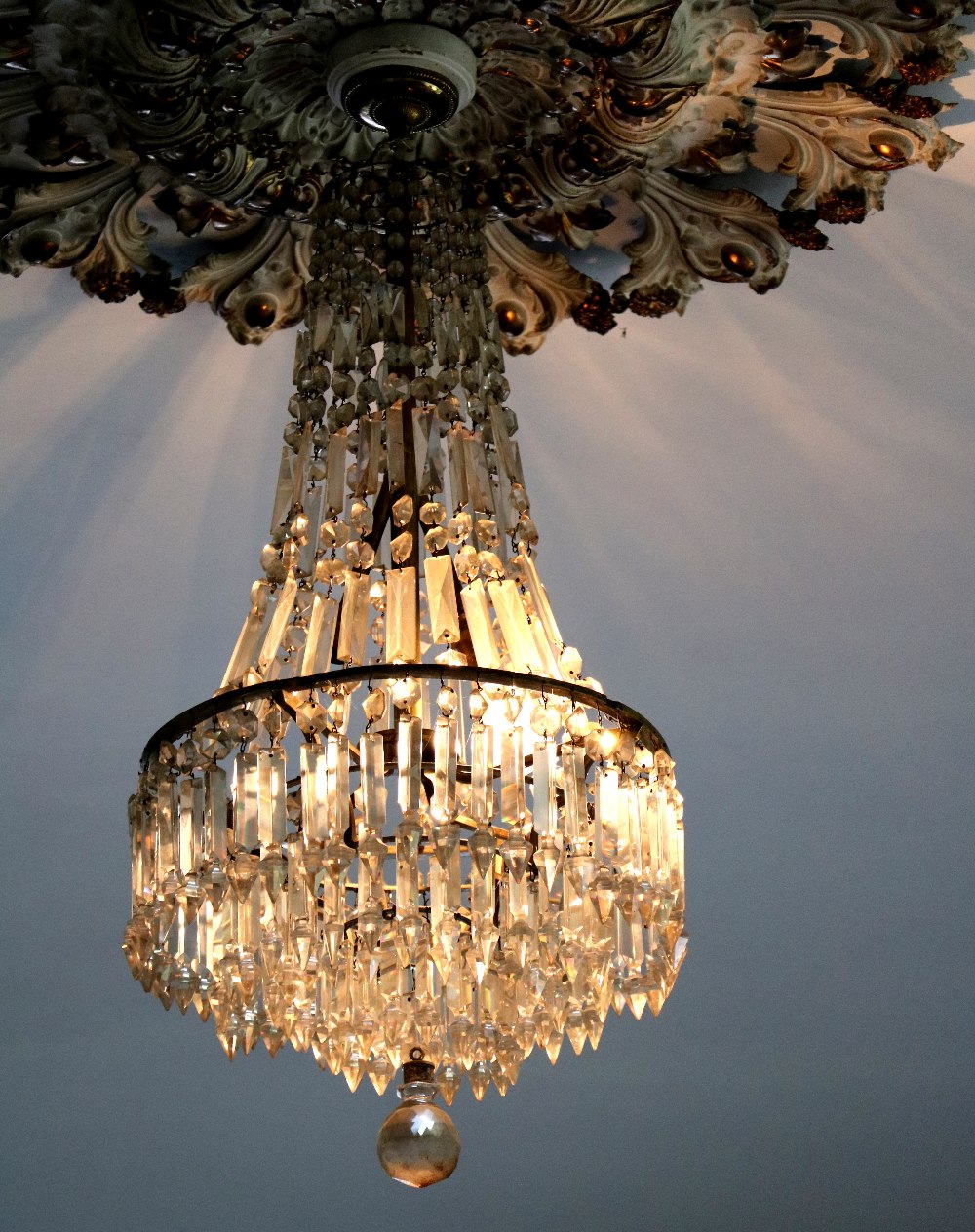 A Regency period glass Ceiling Light, with draped support over a stepped four tier central hanging,