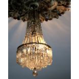 A Regency period glass Ceiling Light, with draped support over a stepped four tier central hanging,