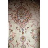 An old Oriental Indian Carpet, fawn ground, pink border, approx. 16' x 12'.