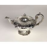 An elegant early Victorian Irish silver Teapot, embossed with floral swags,