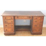 A Victorian walnut pedestal kneehole Writing Desk, the moulded top over central frieze drawers,