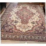 A large woolen Carpet, the cream centre with diamond shaped design and large border, approx.