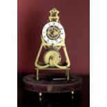 A 19th Century English brass and enamel dial Skeleton Clock, by Davidson London,