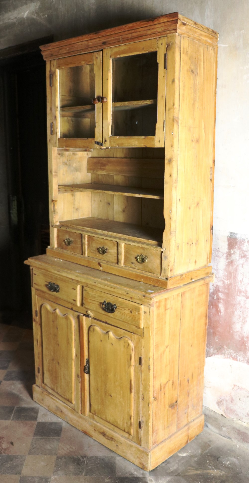 An old stripped two part Pine Dresser, with glass press on top, over drawers and panel doors below.