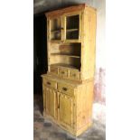An old stripped two part Pine Dresser, with glass press on top, over drawers and panel doors below.