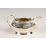 An oval silver Cream Jug, Birmingham 1932, with bead edge, approx. 15cms (6").