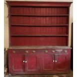 A very large antique pine Dresser, painted red, four shelf top, over three frieze drawers,