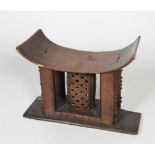 Tribal Art: An early 19th Century African pierced and decorated wooden Headrest, possibly Shona,