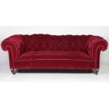 A Victorian period deep button back Chesterfield Couch, with red fabric,