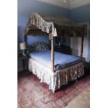 A 19th Century mahogany single four poster Bed, with domed material top and turned pillar uprights.