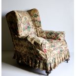 A pair of late Victorian wing back Armchairs, covered in floral cream ground fabric,