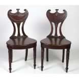 A pair of fine quality Regency period gorget back mahogany Hall Chairs,