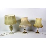 Three varied marble and alabaster Table Lamps, with ormolu mounts and cream shades.