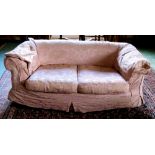 A Chesterfield Couch, of small proportions covered in pink fabric,