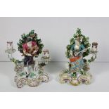 A pair of attractive and colourful Chelsea porcelain figural Candlesticks, (one damaged),