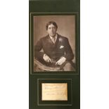 Wilde (Oscar) An original Signature with a vintage Photograph of Wilde seated in dandy attire,
