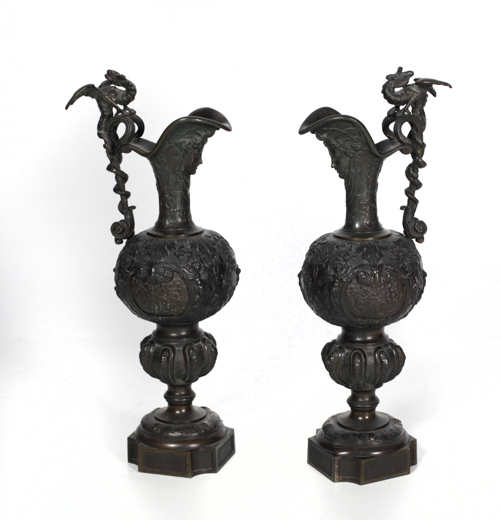 A pair of tall 19th Century heavy bronze Claret Jugs, after the Antique, with dragon handles,