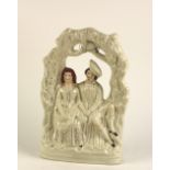 An attractive Staffordshire porcelain Group, of a young couple seated holding hands,