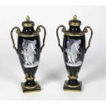An attractive pair of 19th Century tall two handled French porcelain Vases, with lids,