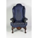 A 19th Century carved mahogany framed blue upholstered high back Wing Armchair,