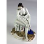 A Continental porcelain Figure, of a seated semi-nude Ballet Dancer, 22cms (8 1/2").