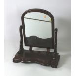 A Victorian dome shaped Dressing Table Mirror, with scroll decorated supports, on a serpentine base,