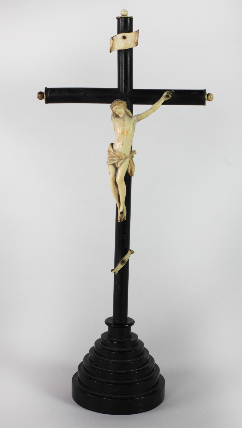 A 19th Century ebony Crucifix, with carved ivory Corpus Christi, some dam.