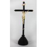A 19th Century ebony Crucifix, with carved ivory Corpus Christi, some dam.