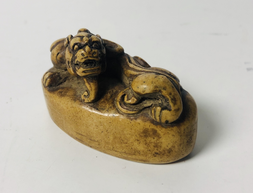 A carved Chinese hard stone Seal, surmounted with a dragon on oval base with character mark on base,