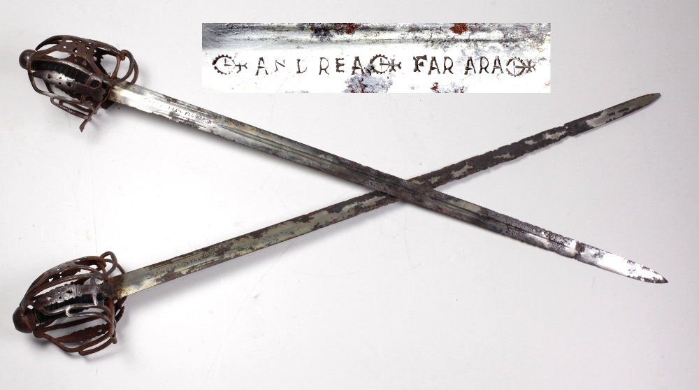 A rare almost matching pair of 17th Century Italian basket hilted Broadswords, with c.