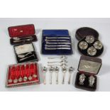 A cased set of four circular silver Salts, with four matching salt spoons,