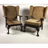 A pair of Georgian style mahogany framed and upholstered Open Armchairs, on front ball n' claw feet.