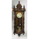 A good quality carved walnut Vienna Wall Wagger, with two brass weights and brass pendulum.