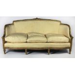 A 19th Century French style carved giltwood Settee, decorative rim covered in yellow silk fabric,