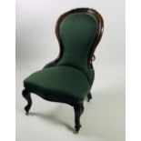 A small Victorian walnut Low Armchair, covered in plain green material, with carved cabriole legs.