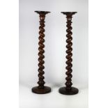 A pair of tall Victorian oak barely twist turned Torcheres,