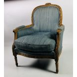 An attractive Louis XV style carved Armchair, with arched back, scroll arms, on front tapering legs,