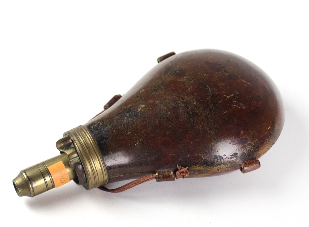 An unusual brass and leather bound leg of mutton Powder Flask.