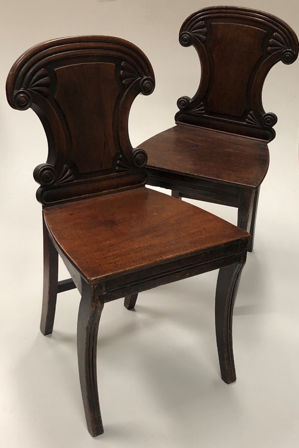 A set of 4 Irish William IV mahogany Hall Chairs, with shield shaped backs, decorative roundels,