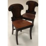 A set of 4 Irish William IV mahogany Hall Chairs, with shield shaped backs, decorative roundels,