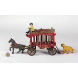 A heavy painted cast metal Model of a Overland Circus horse drawn Carriage, with lion and master.