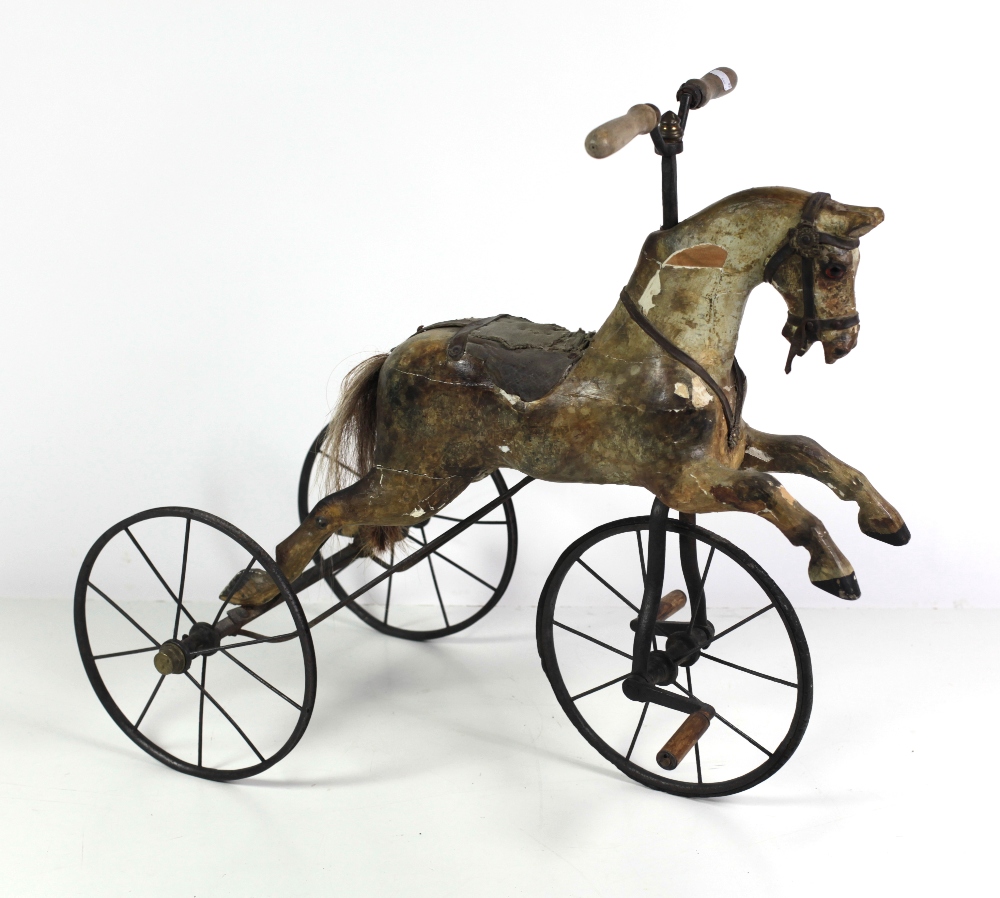 A late Victorian painted wooden Child's Horse Tricycle, with spoked wheels and wooden handles.