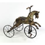 A late Victorian painted wooden Child's Horse Tricycle, with spoked wheels and wooden handles.
