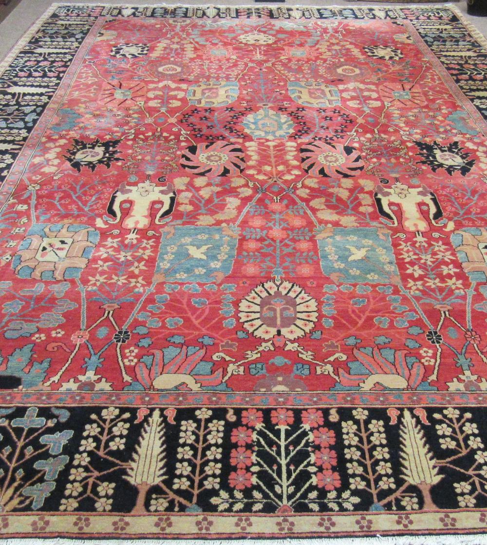 A fine quality Persian 20th Century claret ground Carpet, with a large floral decorated centre,