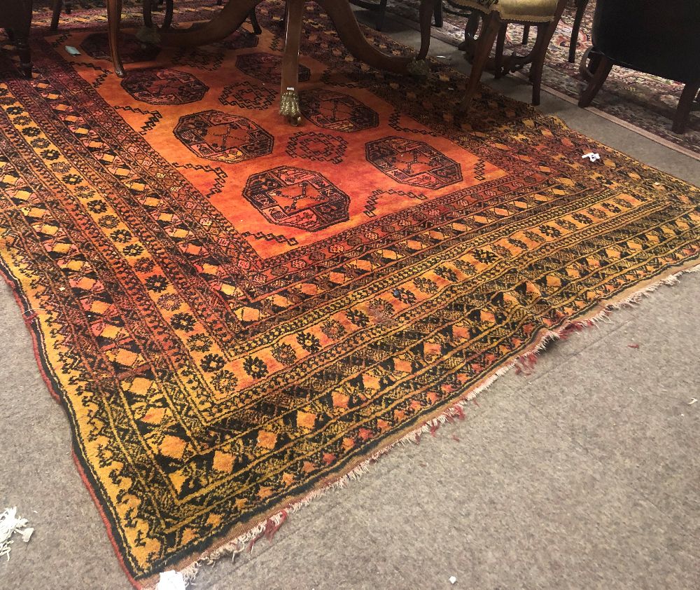 An unusual late 19th Century / early 20th Century Middle Eastern orange ground woollen Carpet,