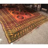 An unusual late 19th Century / early 20th Century Middle Eastern orange ground woollen Carpet,